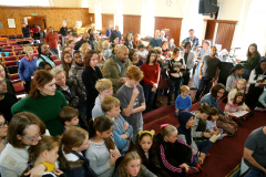 everyone-huddles-at-the-front-to-witness-a-baptism-8776a0